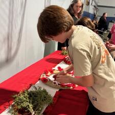 Laying poppies on the wreath